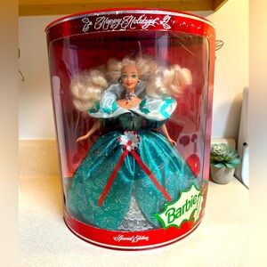 Blonde bombshell holiday Barbie in a gown of shimmering green and holly accents